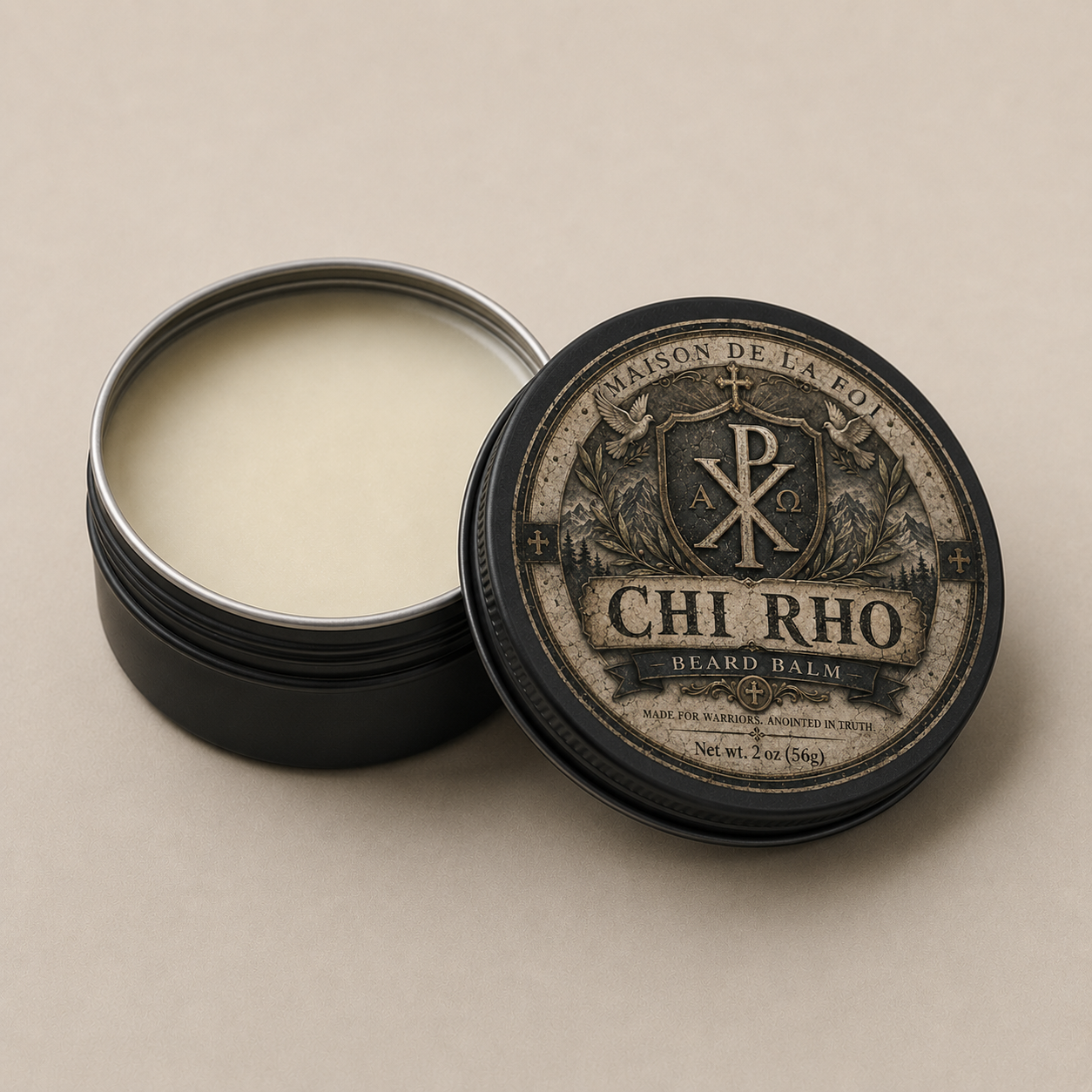 An open round black tin of beard balm with pale cream balm visible inside, next to the lid. The lid has a vintage-style label reading CHI RHO and Maison de la Foi, with a monogram emblem, on a warm beige background.